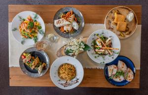 a wooden table with plates of food on it at Hotel Liptov in Belá