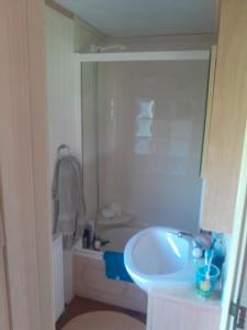 a bathroom with a sink and a bath tub at 254 Bryn y Mor in Tywyn +23 photos
