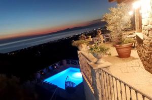a swimming pool on a balcony at night at La Pastorella Boutique Hotel in Diamante