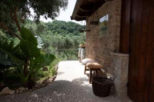 a patio with two chairs and a brick wall at La Pastorella Boutique Hotel in Diamante