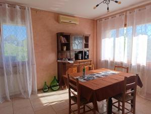 a dining room with a table and some windows at Il Poggio b&b-appartamento in San Marino