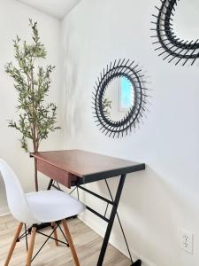 a desk and a chair in a room with a mirror at Le Cozy Unit #3 2 Bedroom in Quebec in Quebec City