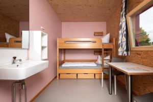 a small room with a sink and a bunk bed at Jugendherberge Hohenstaufen in Göppingen +12 photos