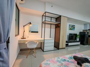 a bedroom with a desk and a bed and a mirror at Alinea Suites Shah Alam in Shah Alam +26 photos