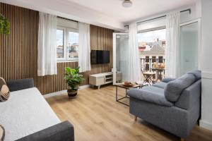 Televízia a/alebo spoločenská miestnosť v ubytovaní WonderStays Apartamentos Morgan