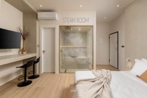 a bedroom with a bed and a desk and a window at Selected Suites in Chania