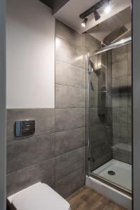 a bathroom with a shower and a toilet at Prestigious Main Square Apartment in Kraków