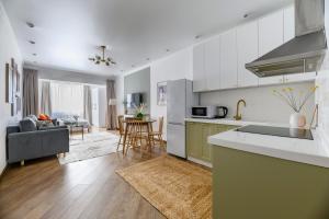 a kitchen and living room with a couch and a table at Arbat, Golden Square, center in Almaty