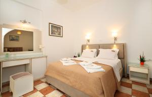 Postel nebo postele na pokoji v ubytování Hotel Klonos - Kyriakos Klonos
