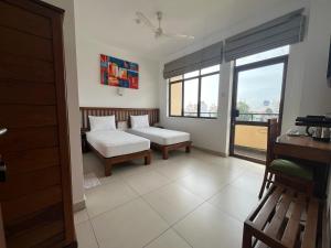 A bed or beds in a room at Port View City Hotel