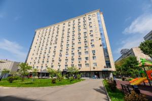 a large building with a playground in front of it at Arbat, Golden Square, center in Almaty