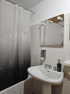 a bathroom with a sink and a shower curtain at La Lanterna in Corniglia