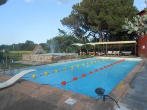 a large blue swimming pool with a fountain at Kormoransee Ferien in Pucciarelli