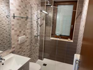 a bathroom with a shower and a toilet and a sink at Puglia Suite in Casamassima +11 photos