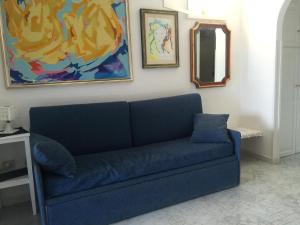a blue couch in a living room with a mirror at Flach D in Lipari