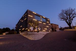 a building with lights on the side of it at Casa Le Vaglie in Barbara