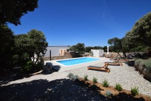 a swimming pool with two loungers and a poolvisorvisor at Ferienhaus In Mandre Mit Großer Terrasse in Mandre +30 photos