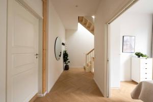 a hallway with a white door and a staircase at Stunning Premium Apartment with Private Rooftop in Copenhagen +44 photos
