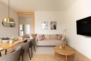a living room with a table and a couch at Stunning Premium Apartment with Private Rooftop in Copenhagen