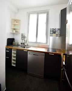 a kitchen with a sink and a window at Charming T2 on the outskirts of Paris in Saint-Ouen