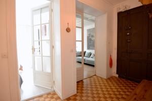 a hallway with a door leading to a living room at Charming T2 on the outskirts of Paris in Saint-Ouen
