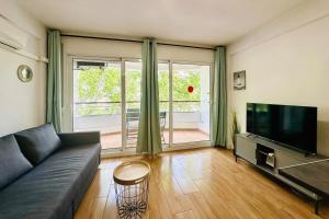 a living room with a couch and a flat screen tv at Home Formentor Salou in Salou