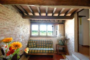 a living room with a couch and a window at Rotreiher Urlaub Am Trasimeno See in Pucciarelli