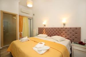 Postel nebo postele na pokoji v ubytování Hotel Klonos - Kyriakos Klonos