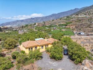 an aerial view of a yellow house with a mountain at Casa El Salto in Los Llanos de Aridane