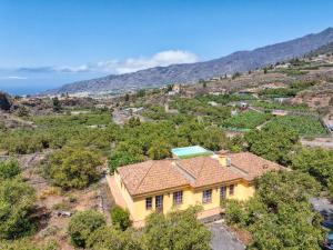 an aerial view of a yellow house on a hill at Casa El Salto in Los Llanos de Aridane