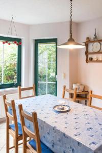 a dining room table and chairs with a blue table cloth at Löwenzahn Mit Holu in Zehdenick