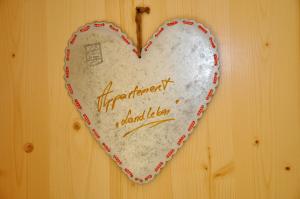 a heart shaped sign on a wooden wall at Ferienwohnung Landleben In Feistritz Ob Bleiburg in Feistritz ob Bleiburg