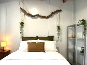 a bedroom with a bed with plants on the wall at Blue Emerald in Haifa
