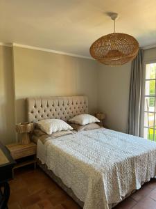 a bedroom with a bed with a white comforter at Maison LouLou in Cogolin +69 photos