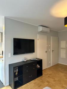 a living room with a flat screen tv on a wall at Amaroom 4 in Karlsruhe