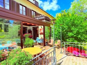 a patio with a table and chairs on a balcony at Penzion Villa Ancora in Šumperk