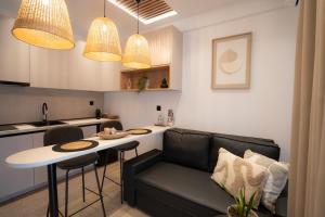 a kitchen and living room with a couch and a table at Meteora vibes in Kalabaka
