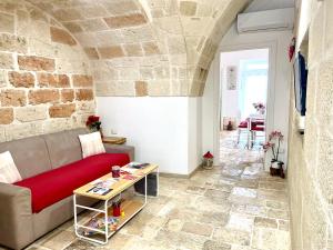 a living room with a couch and a table at Antica Pietra in Polignano a Mare