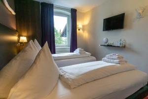 Postel nebo postele na pokoji v ubytování Hotel Wetterstein
