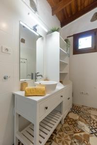 a bathroom with a sink and a mirror at Casa Rural Cottage Bentayga in Tejeda +31 photos