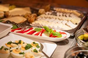 a table topped with plates of food and desserts at Strandhotel Sylt Westerland in Westerland