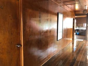 バリック・プラウにあるQuadruple Traditional Wooden GuestHouseの木の壁とドアのある部屋