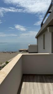 a view of the beach from the balcony of a house at Hotel Progni in Shëngjin +14 photos