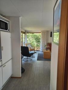 a living room with a couch and a chair at Chalet "Uit Zicht" in Putten