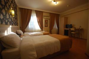 Postel nebo postele na pokoji v ubytování Mini Hotel