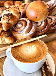 a cup of coffee next to a tray of pastries at Sirdal fjellpark in Tjørhom