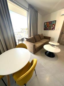 a living room with a couch and a table and chairs at Verasia Acute Stay in Engomi in Engomi