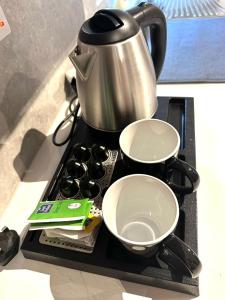 a stove top with two pans and a pot on it at Verasia Acute Stay in Engomi in Engomi +36 photos