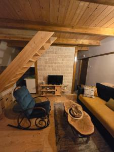 sala de estar con sofá y silla en Durmitor Chill Chalet, en Žabljak