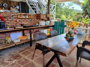 a wooden table and chairs in a kitchen at Homestay Đồi Sương Trắng in Da Lat